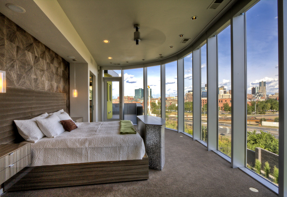 This is an example of a contemporary master bedroom in Denver with carpet, no fireplace and a feature wall.