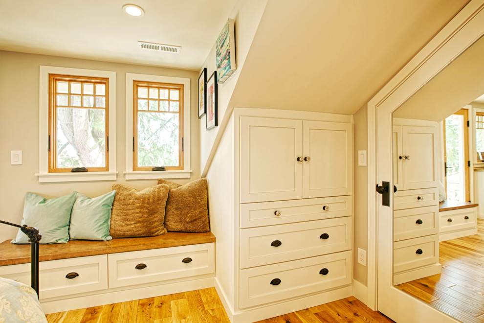 Diseño de dormitorio de estilo americano pequeño con paredes azules y suelo de madera en tonos medios