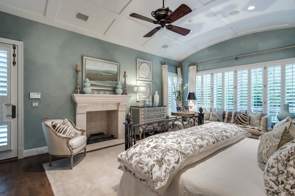Inspiration for a large transitional master medium tone wood floor bedroom remodel in Dallas with blue walls, a standard fireplace and a stone fireplace