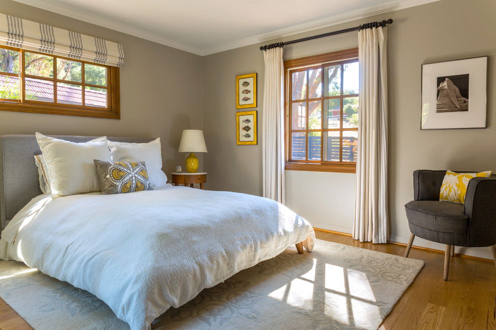 Inspiration for a mid-sized transitional guest medium tone wood floor bedroom remodel in Los Angeles with gray walls