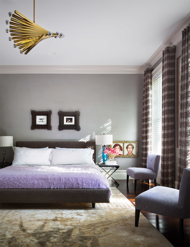 This is an example of a classic bedroom in New York with grey walls and dark hardwood flooring.