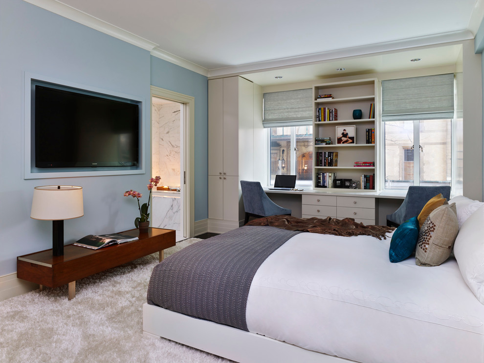 Example of a mid-sized trendy master carpeted and white floor bedroom design in New York with blue walls and no fireplace
