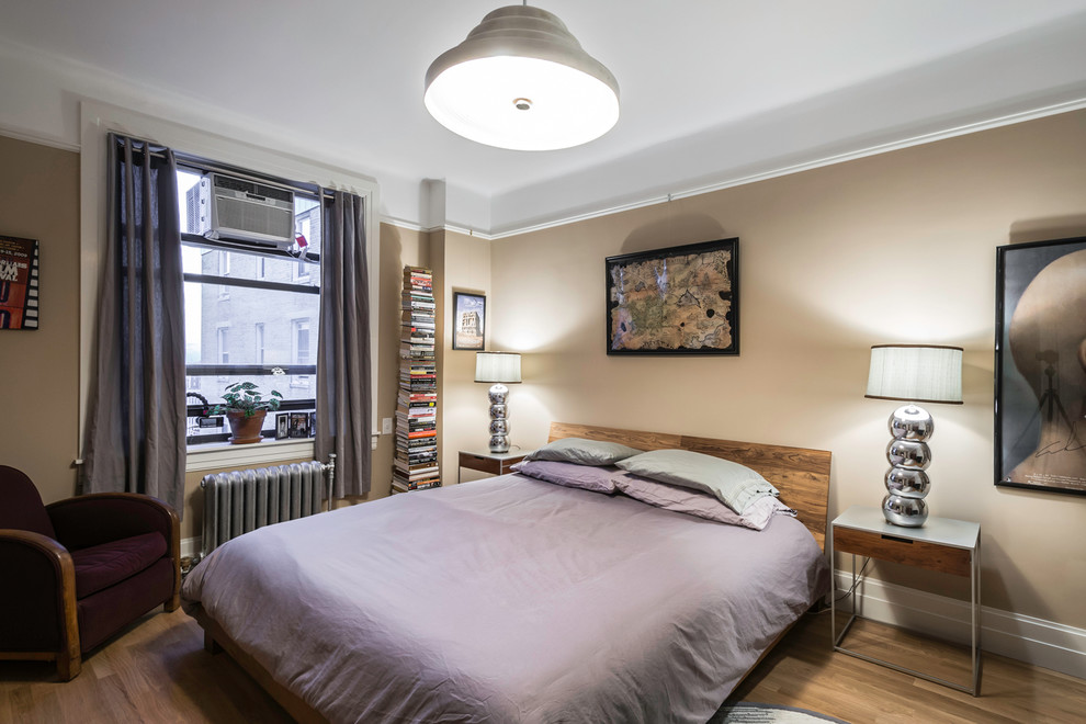 Medium sized contemporary master bedroom in New York with beige walls and medium hardwood flooring.