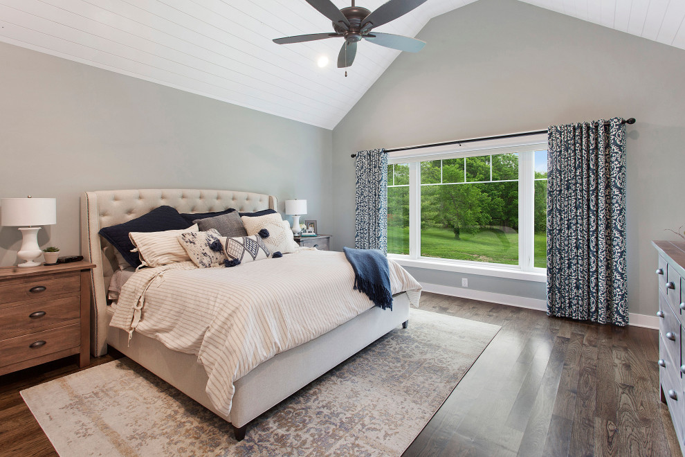 Example of a large cottage master dark wood floor and brown floor bedroom design in Kansas City with gray walls and no fireplace