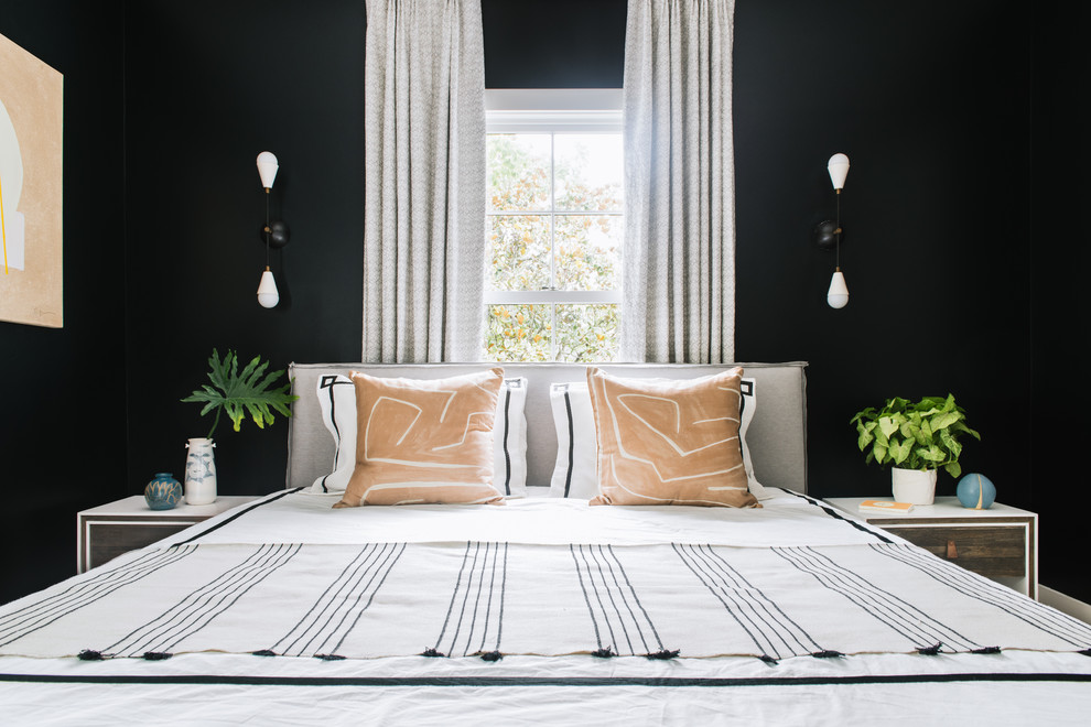 Traditional master bedroom in Charleston with black walls.