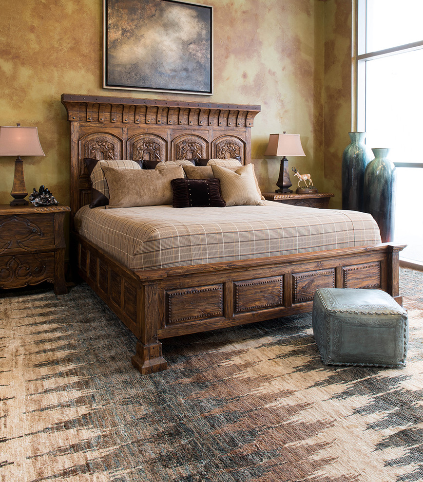 This is an example of a large rustic master bedroom in Houston with carpet.
