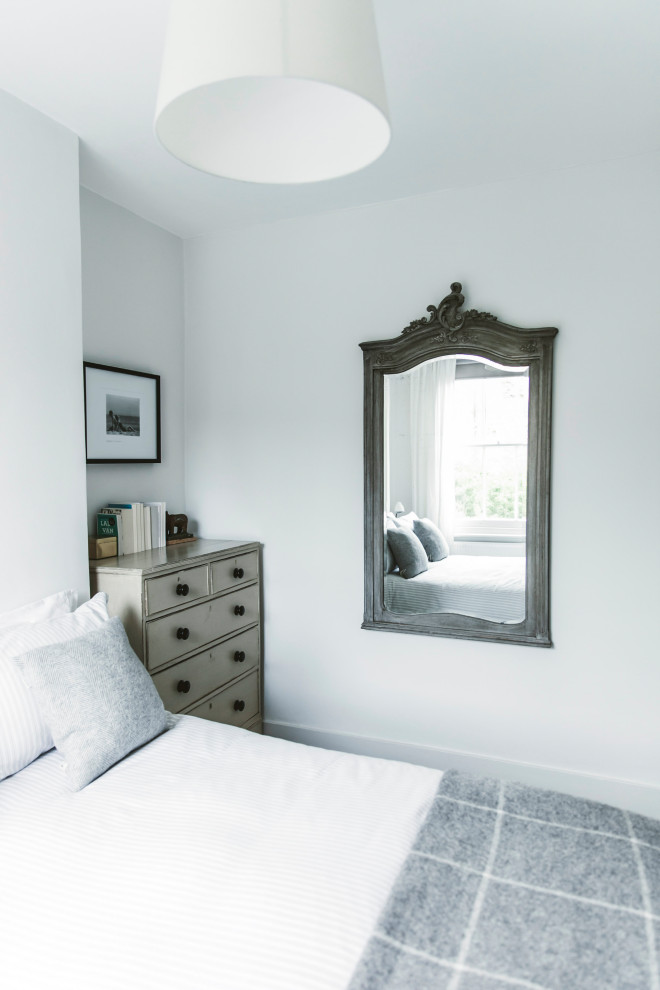 This is an example of a contemporary guest bedroom in London with grey walls, carpet and grey floors.
