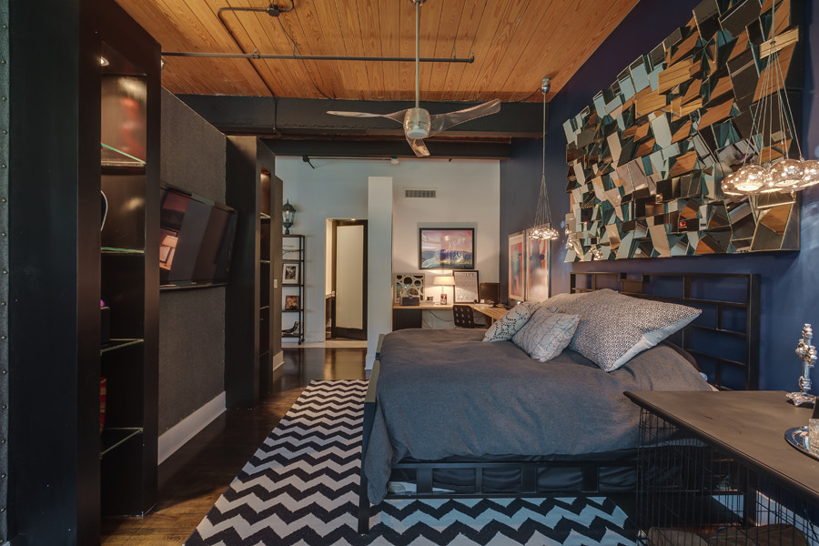 Example of a mid-sized urban master painted wood floor and brown floor bedroom design in Charlotte with black walls and no fireplace