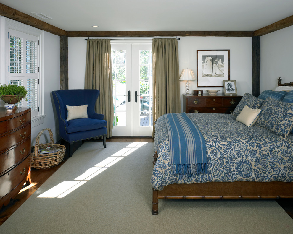 Inspiration for a mid-sized timeless guest medium tone wood floor bedroom remodel in Boston with white walls