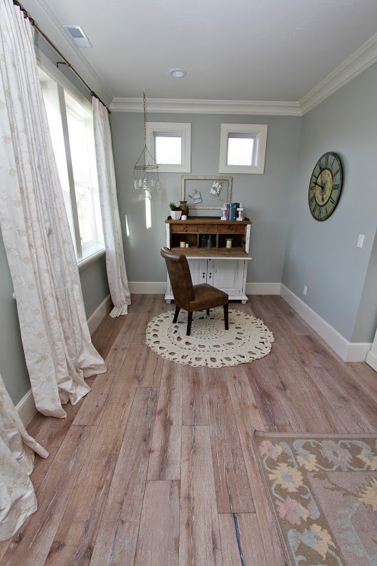 Large farmhouse guest light wood floor bedroom photo in Salt Lake City with gray walls and no fireplace