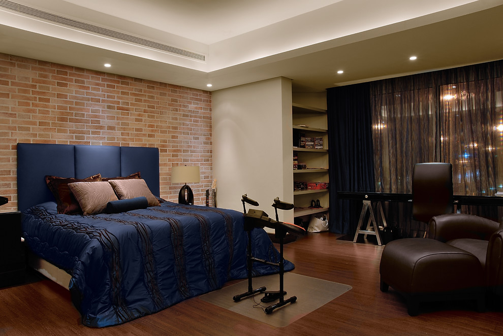 This is an example of a contemporary bedroom in Other with beige walls, medium hardwood flooring and a feature wall.