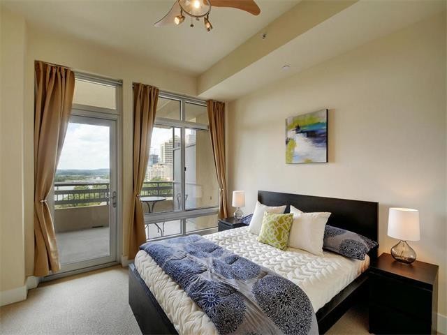 This is an example of a modern master bedroom in Austin with carpet.