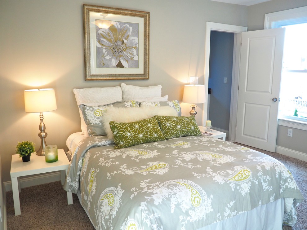 This is an example of a medium sized traditional master bedroom in Boston with grey walls and carpet.