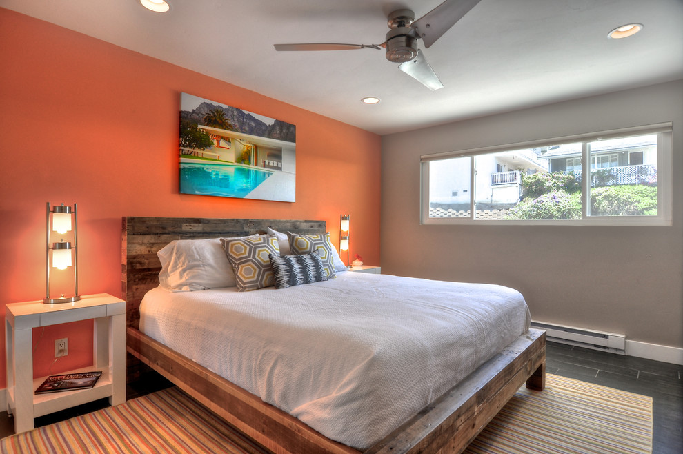 World-inspired grey and silver bedroom in Orange County with orange walls.