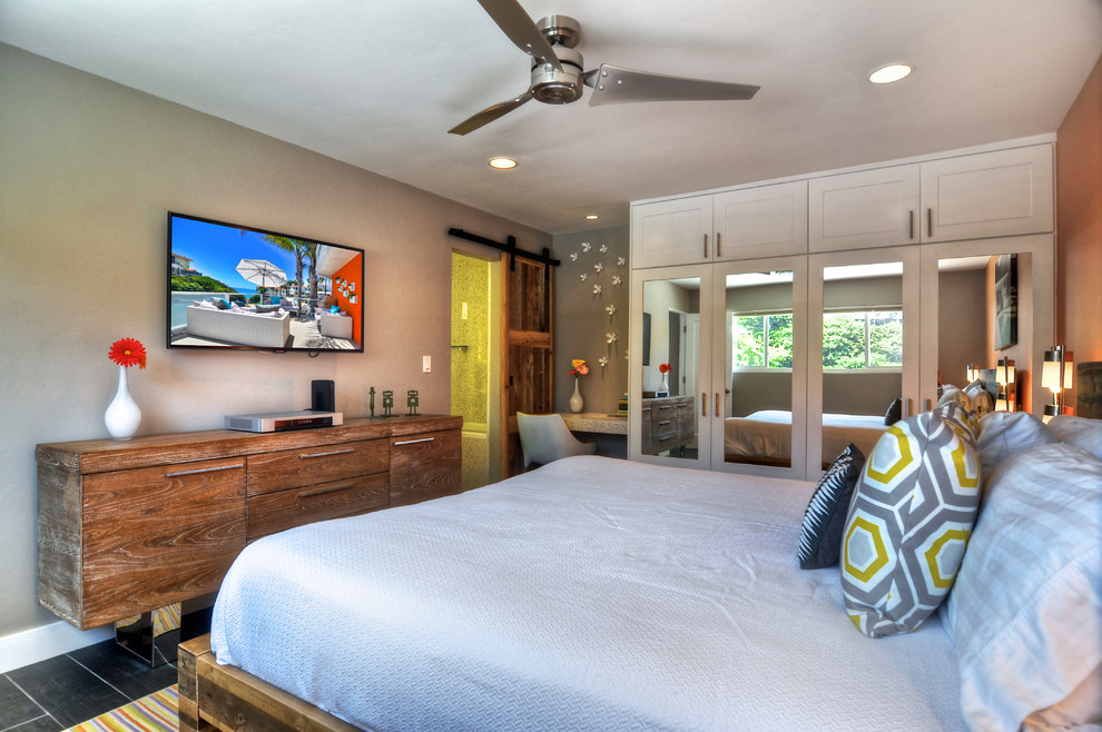 Example of an island style bedroom design in Orange County with gray walls