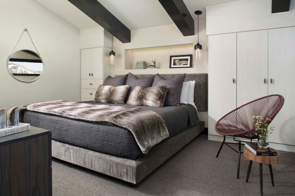 This is an example of a contemporary master bedroom in Denver with white walls, carpet and no fireplace.