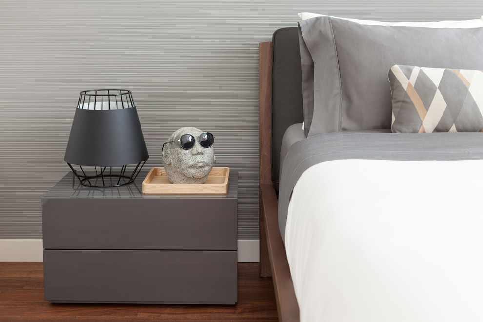 Ejemplo de dormitorio moderno con paredes grises y suelo de madera en tonos medios