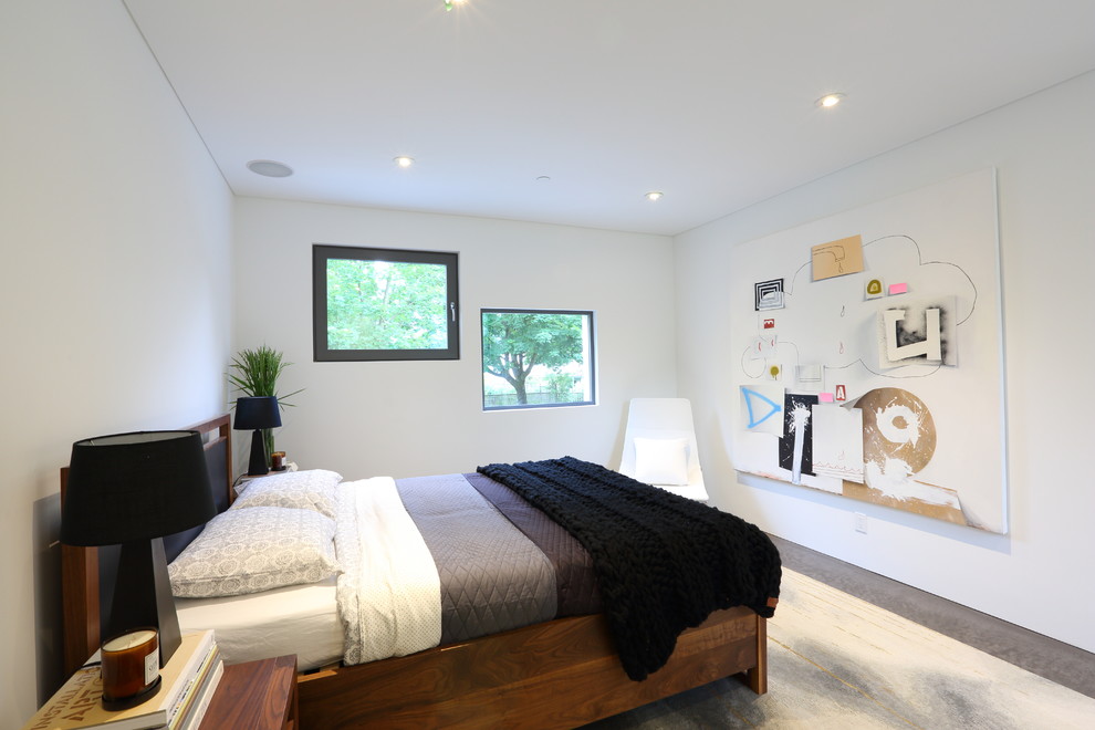 Inspiration for a mid-sized contemporary master concrete floor bedroom remodel in Vancouver with white walls