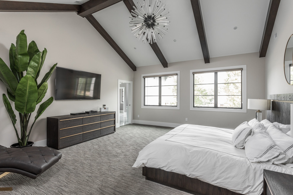 Photo of a modern master bedroom in Indianapolis with beige walls, carpet and grey floors.