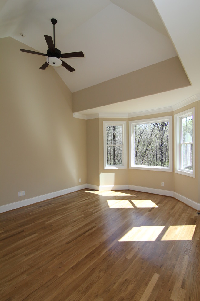 Inspiration for a medium sized traditional master bedroom in Raleigh with beige walls and medium hardwood flooring.