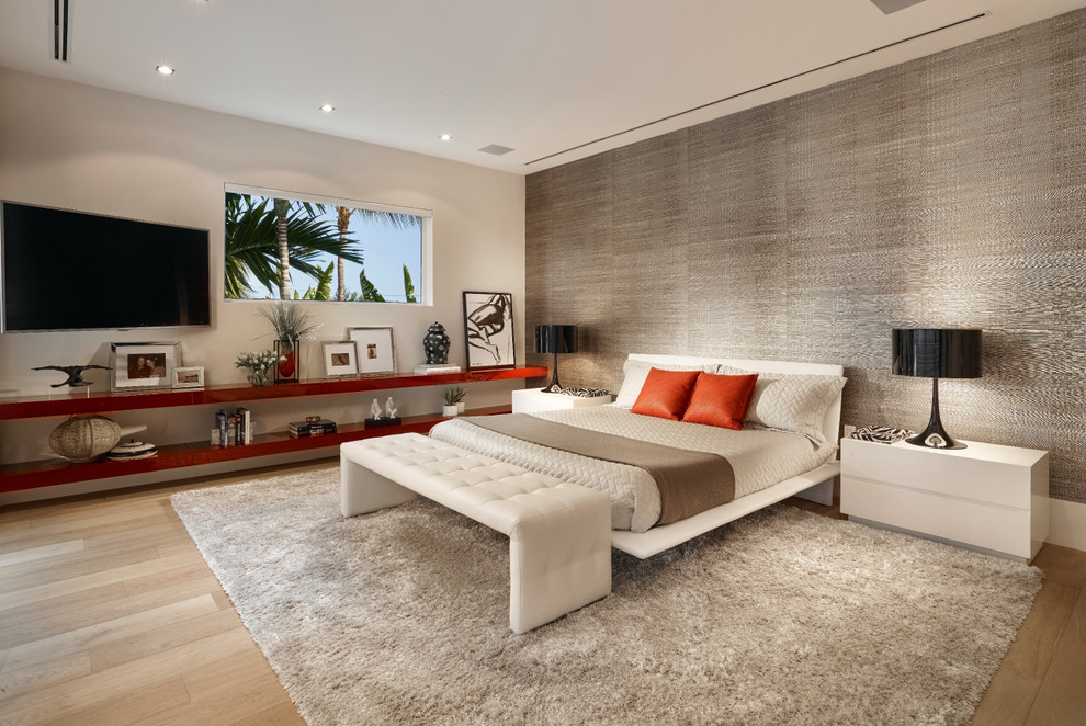Example of a large trendy master light wood floor bedroom design in Miami with gray walls and no fireplace