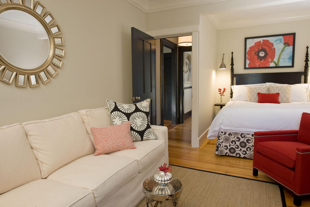 Trendy master medium tone wood floor bedroom photo in Boston with beige walls and no fireplace