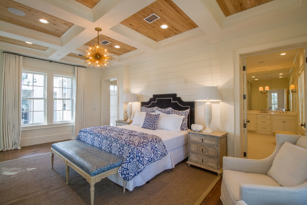 Photo of a beach style bedroom in Miami with white walls, dark hardwood flooring, no fireplace and feature lighting.