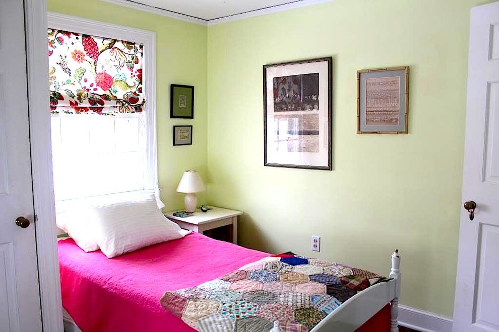 This is an example of a small eclectic guest bedroom in Burlington with green walls and dark hardwood flooring.