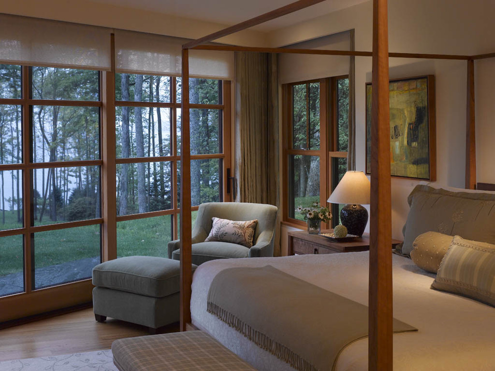 Example of a mountain style master light wood floor bedroom design in Burlington with beige walls and no fireplace