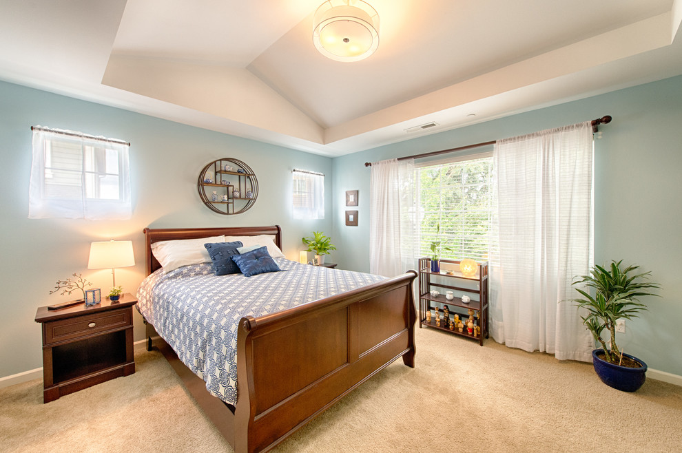 Bedroom - large master carpeted bedroom idea in Seattle with blue walls