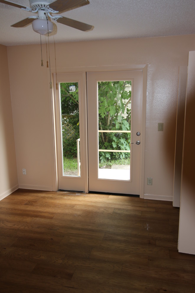 This is an example of a medium sized traditional guest bedroom in Austin with dark hardwood flooring and brown floors.