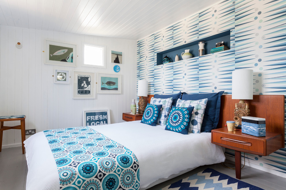 Beach style painted wood floor bedroom photo in London with white walls