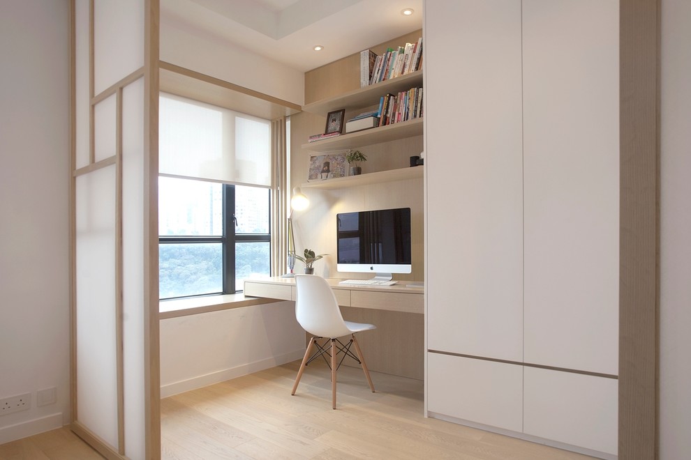 Photo of a medium sized modern master bedroom in Hong Kong with white walls and light hardwood flooring.