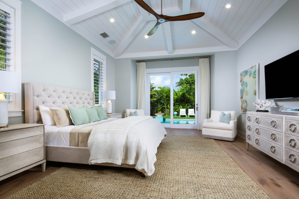 Inspiration for a transitional guest medium tone wood floor and brown floor bedroom remodel in Miami with gray walls