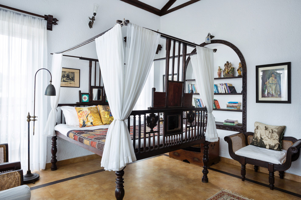 Inspiration for a world-inspired bedroom in Pune with white walls and beige floors.