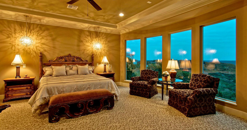 Design ideas for a large mediterranean master bedroom in Austin with brown walls, carpet and no fireplace.