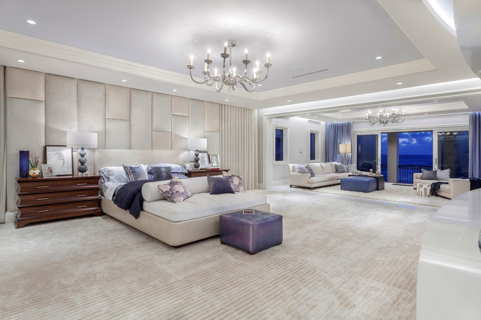 Photo of an expansive contemporary master bedroom in Miami with carpet.