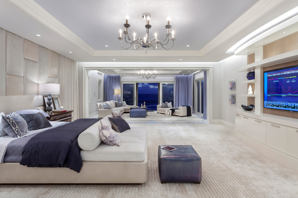 Expansive contemporary master bedroom in Miami with carpet.