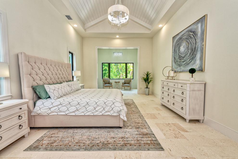 Example of a master beige floor bedroom design in Miami with white walls