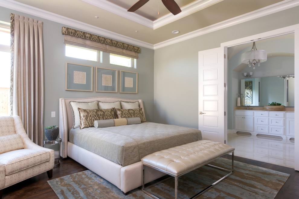 Modelo de dormitorio principal clásico renovado de tamaño medio con paredes azules y suelo de madera oscura