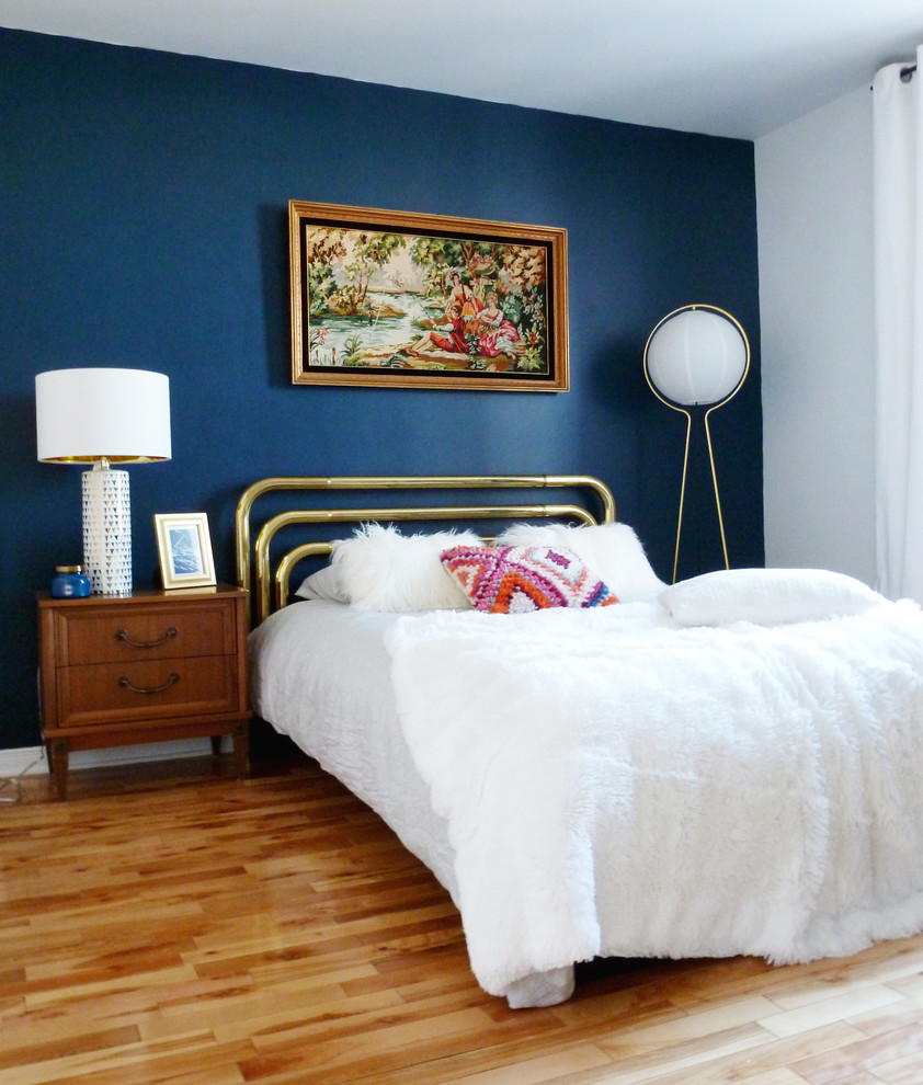 Foto di una camera matrimoniale moderna di medie dimensioni con pareti blu, parquet chiaro, nessun camino e pavimento marrone
