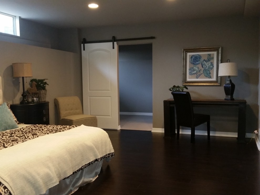 Large classic guest bedroom in Los Angeles with grey walls and dark hardwood flooring.