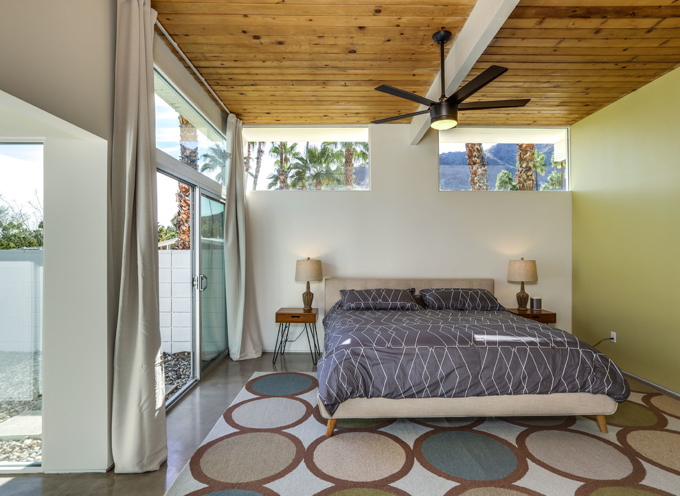 他の地域にあるミッドセンチュリースタイルのおしゃれな寝室 (緑の壁、コンクリートの床、グレーの床) のインテリア