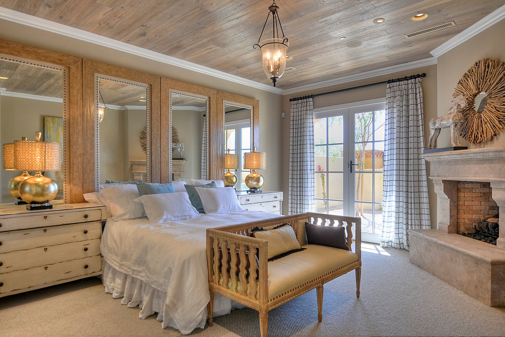 Large classic master bedroom in Phoenix with beige walls, carpet and a stone fireplace surround.