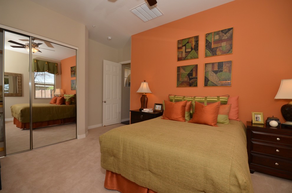 Example of a mid-sized classic guest carpeted bedroom design in Phoenix with orange walls