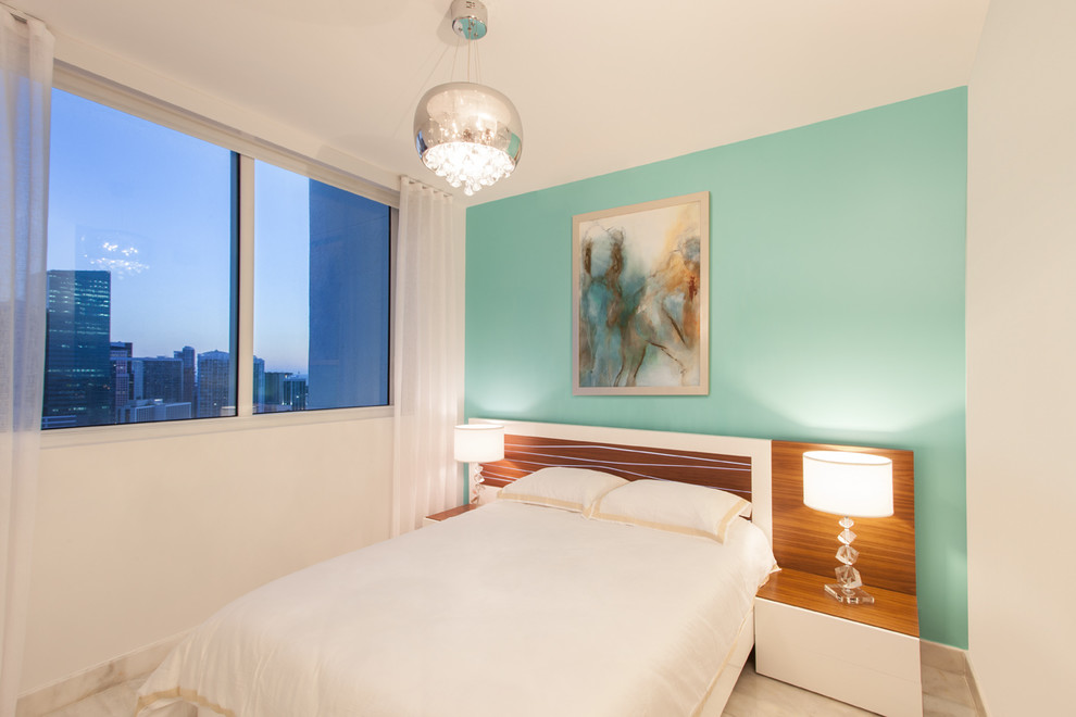This is an example of a small contemporary guest bedroom in Miami with blue walls.