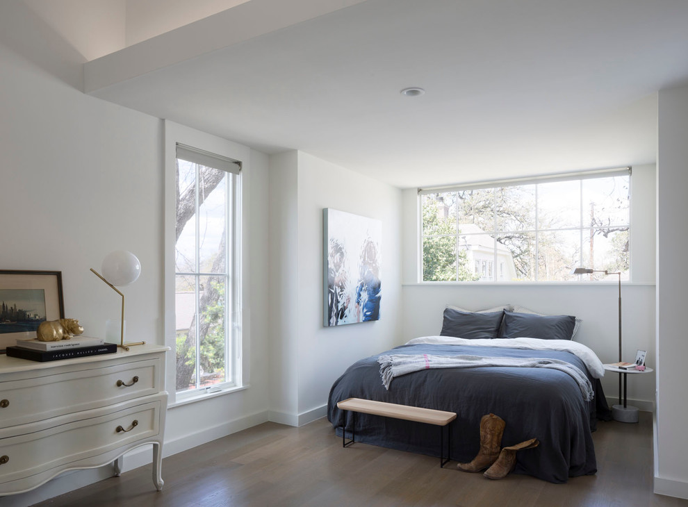 Photo of a traditional bedroom in Austin with white walls and dark hardwood flooring.