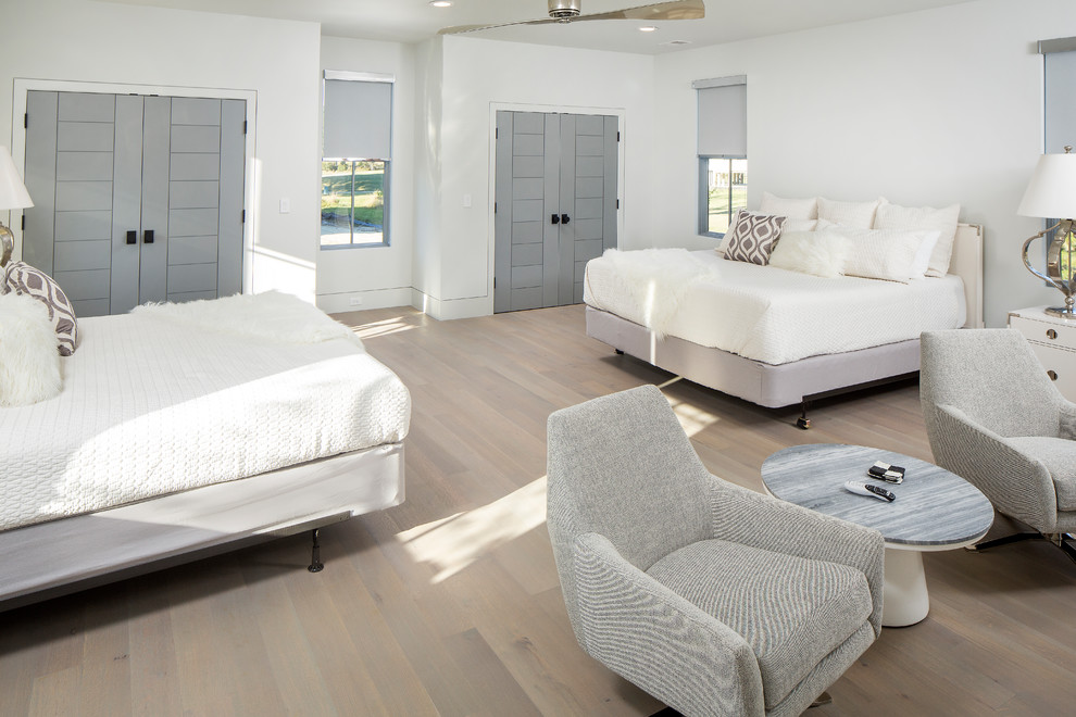 This is an example of an expansive contemporary guest bedroom in Charleston with grey walls, medium hardwood flooring and multi-coloured floors.