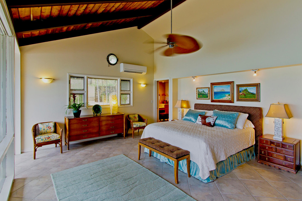 Example of a large island style master ceramic tile and beige floor bedroom design in Hawaii with white walls and no fireplace