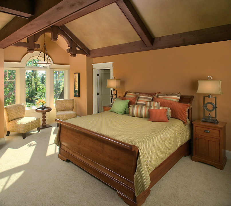 This is an example of a large traditional master bedroom in Grand Rapids with beige walls and carpet.